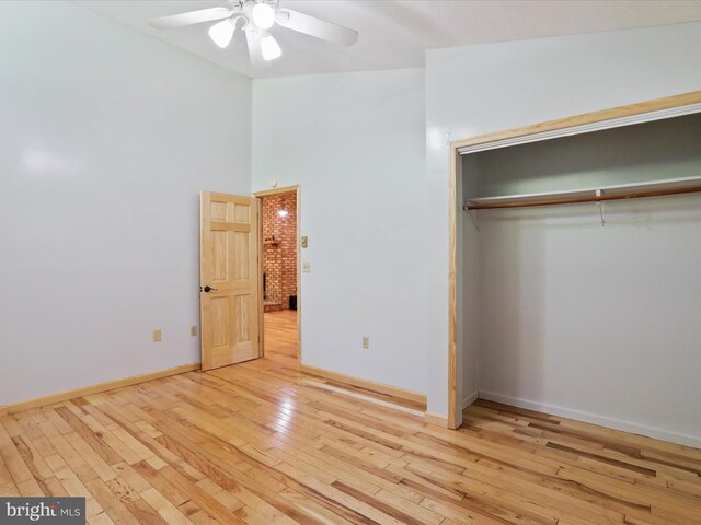 unfurnished bedroom featuring a closet, ceiling fan, and light wood-type flooring