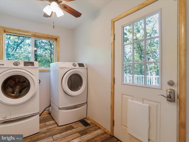 laundry room with separate washer and dryer, light hardwood / wood-style floors, and ceiling fan