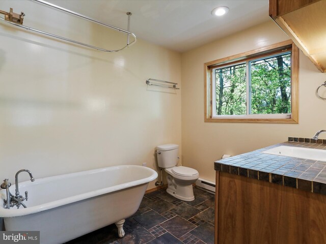 bathroom featuring vanity, a bath, toilet, and baseboard heating