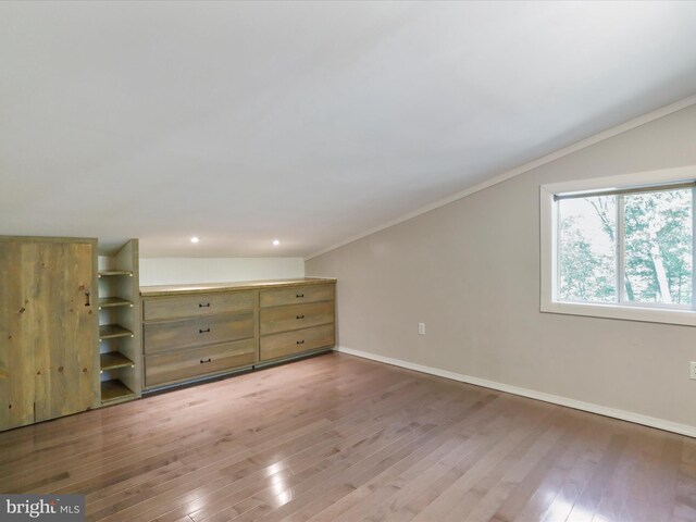 additional living space featuring vaulted ceiling and hardwood / wood-style floors