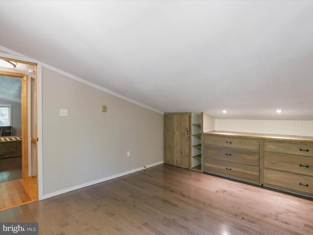 additional living space with dark hardwood / wood-style flooring and lofted ceiling