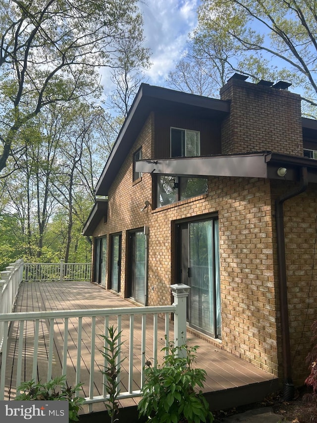 rear view of property with a wooden deck