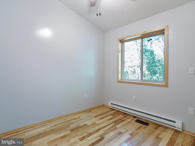 empty room with baseboard heating, ceiling fan, and light wood-type flooring