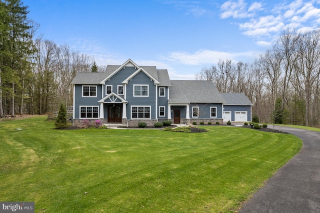 view of front of home with a garage and a front yard