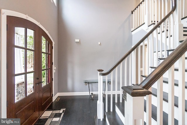 foyer entrance with dark hardwood / wood-style flooring, french doors, and a high ceiling