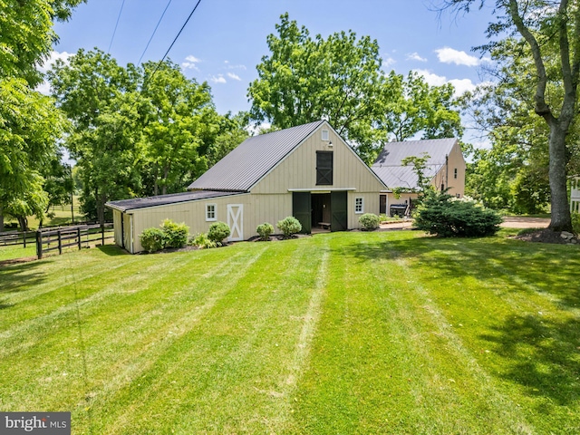 rear view of house featuring a lawn