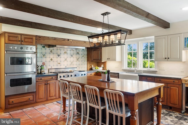 kitchen featuring decorative backsplash, sink, beamed ceiling, and appliances with stainless steel finishes