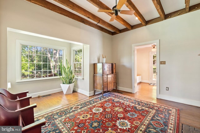 sitting room featuring beam ceiling, ceiling fan, and wood-type flooring