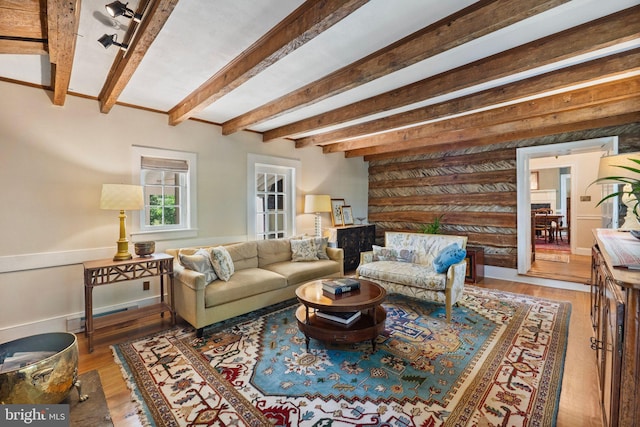 living room with hardwood / wood-style floors and beamed ceiling