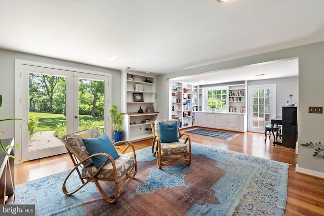 sitting room with hardwood / wood-style floors and french doors