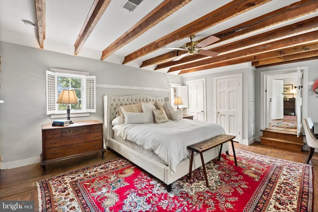 bedroom with hardwood / wood-style flooring, ceiling fan, and beam ceiling