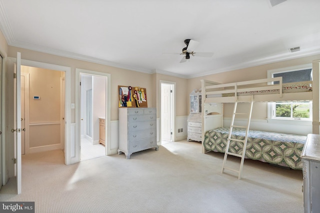 bedroom with ceiling fan, crown molding, connected bathroom, and light carpet