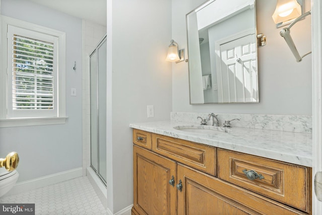 bathroom featuring tile patterned flooring, vanity, toilet, and walk in shower