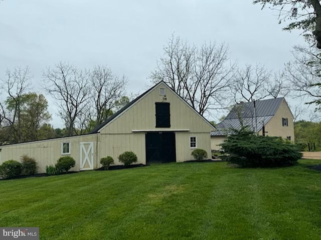 view of outbuilding with a yard