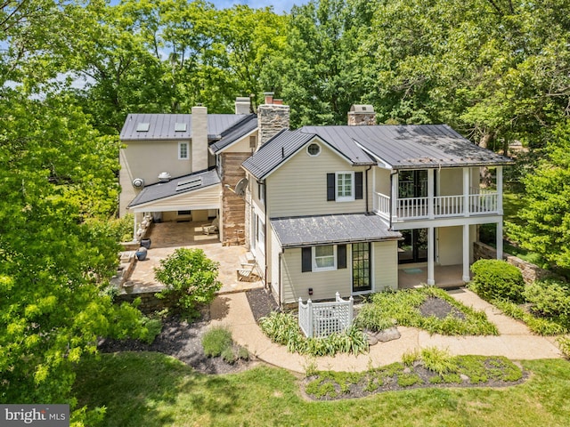 back of property with a patio area and a balcony