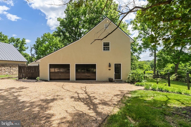 back of property featuring a garage