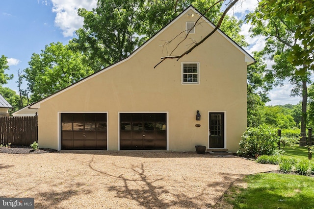 rear view of property with a garage