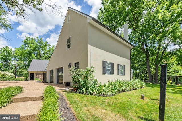 view of side of home featuring a yard