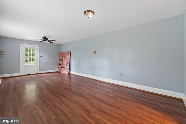 unfurnished living room featuring dark hardwood / wood-style floors and ceiling fan