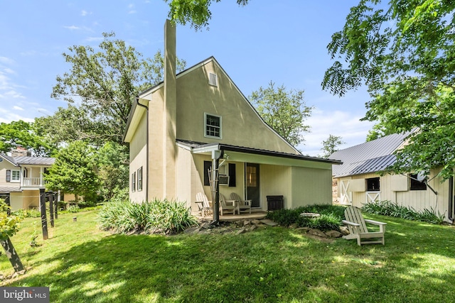 rear view of house with a yard