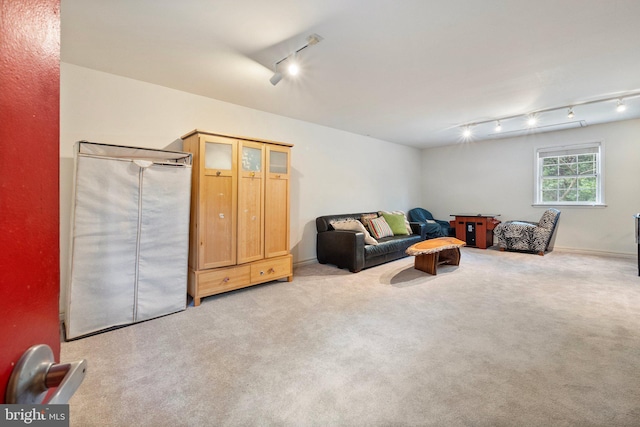 carpeted living room featuring rail lighting