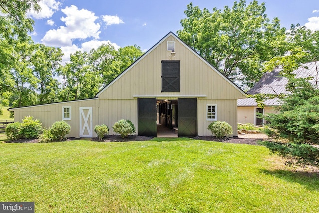 view of outbuilding featuring a lawn