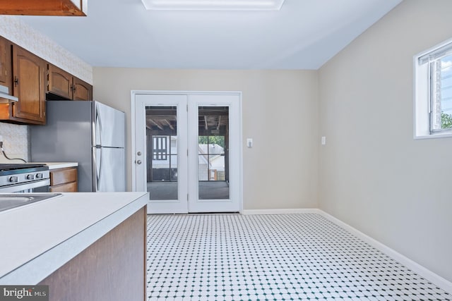 1722 Selma Ave, Halethorpe, MD 21227 - kitchen with light flooring, light countertops, decorative backsplash, stove, and freestanding refrigerator