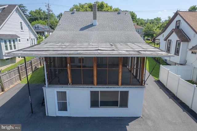 1722 Selma Ave, Halethorpe, MD 21227 - back of property with a shingled roof, a sunroom, and a fenced backyard