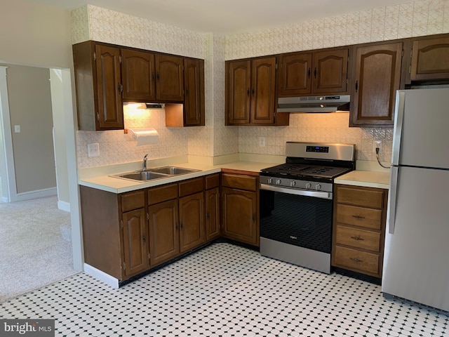 1722 Selma Ave, Halethorpe, MD 21227 - kitchen with freestanding refrigerator, under cabinet range hood, stainless steel gas range oven, light countertops, and dark brown cabinets