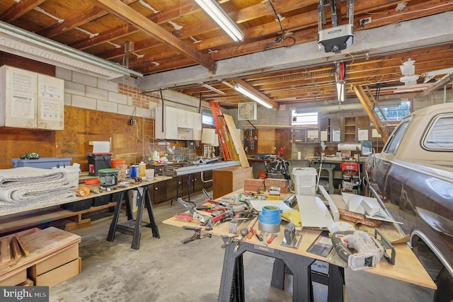 1722 Selma Ave, Halethorpe, MD 21227 - garage featuring a workshop area, a garage door opener, and concrete block wall