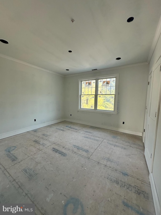 spare room with crown molding