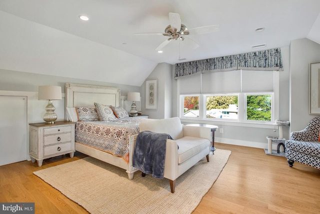 bedroom with ceiling fan, vaulted ceiling, and light hardwood / wood-style floors