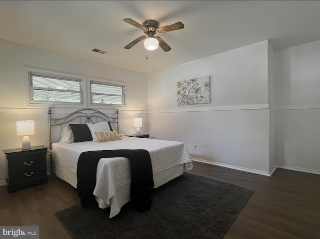 bedroom with dark hardwood / wood-style flooring and ceiling fan