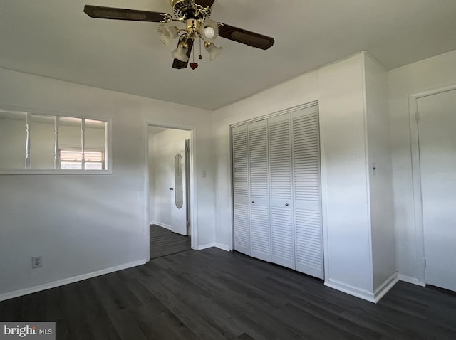 unfurnished bedroom with a closet, ceiling fan, and dark wood-type flooring