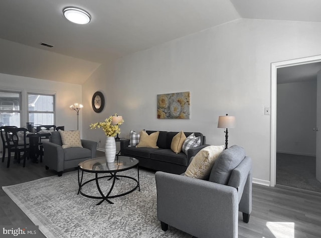 living room with hardwood / wood-style floors and vaulted ceiling