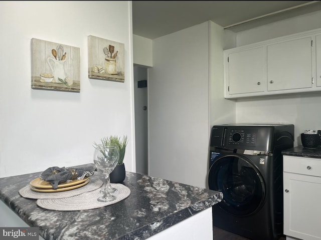 laundry room with cabinets and washer / dryer