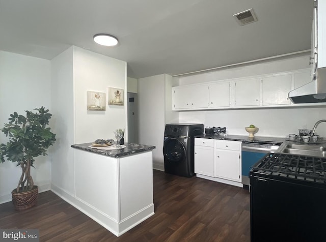 kitchen featuring gas range, sink, white cabinets, dark wood-type flooring, and washer / dryer