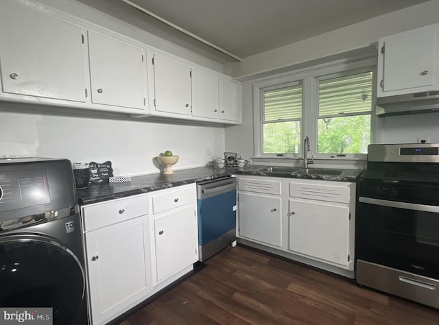 kitchen with white cabinets, dark hardwood / wood-style flooring, appliances with stainless steel finishes, and washer / clothes dryer