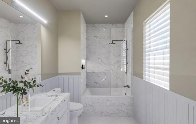 full bathroom featuring toilet, vanity, radiator, and tiled shower / bath