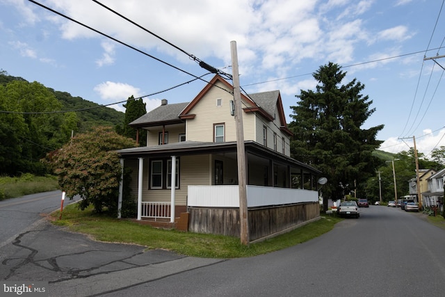 view of side of property with covered porch