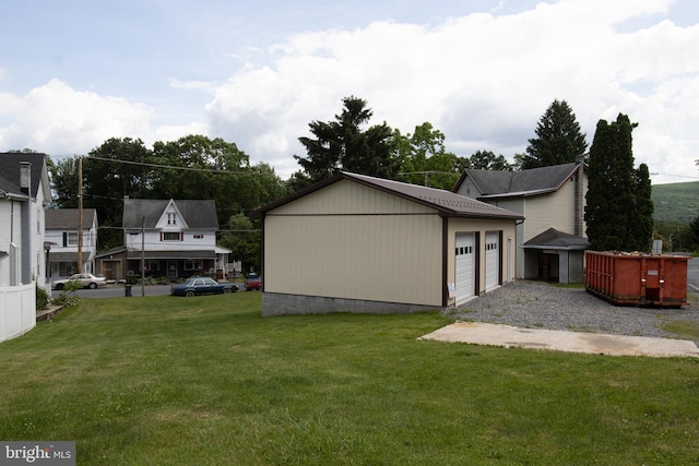 view of property exterior with a lawn, a garage, and an outdoor structure