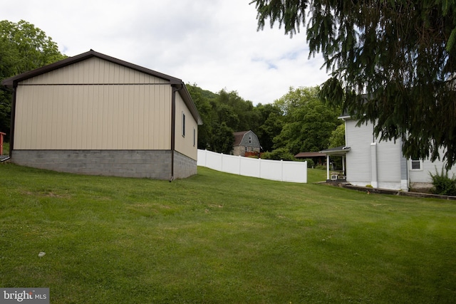 view of side of home with a yard