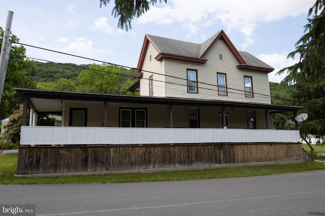 view of side of home with covered porch