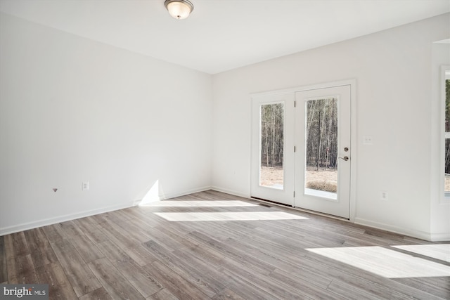 unfurnished room featuring hardwood / wood-style flooring