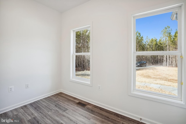 empty room with hardwood / wood-style floors