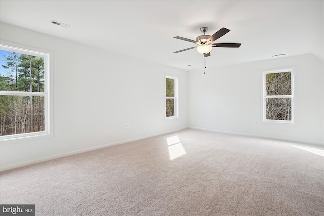 unfurnished room with ceiling fan and carpet