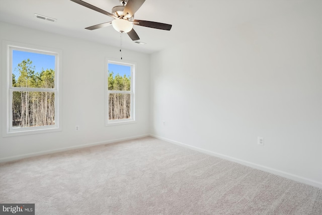 carpeted spare room with ceiling fan