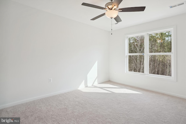 unfurnished room featuring ceiling fan and carpet flooring