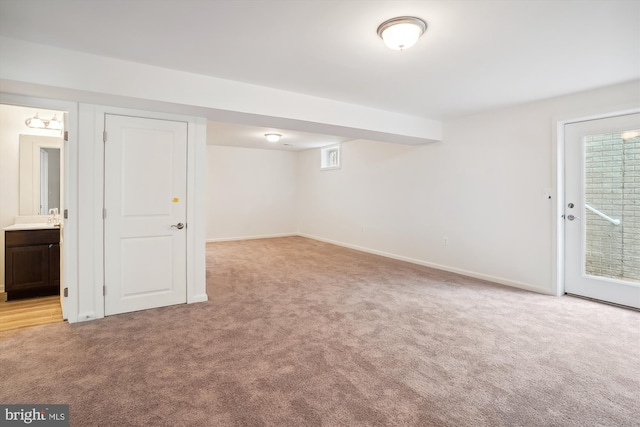 basement featuring light carpet