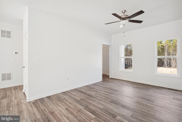 empty room featuring wood-type flooring and ceiling fan